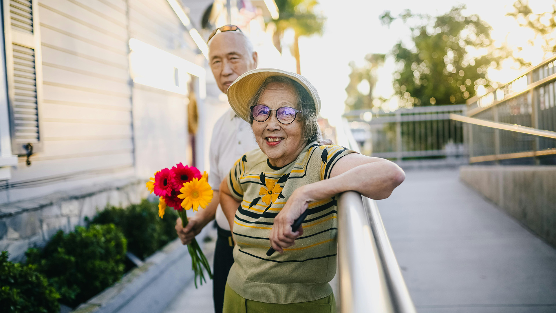 An older couple taking a break during a summer walk outside