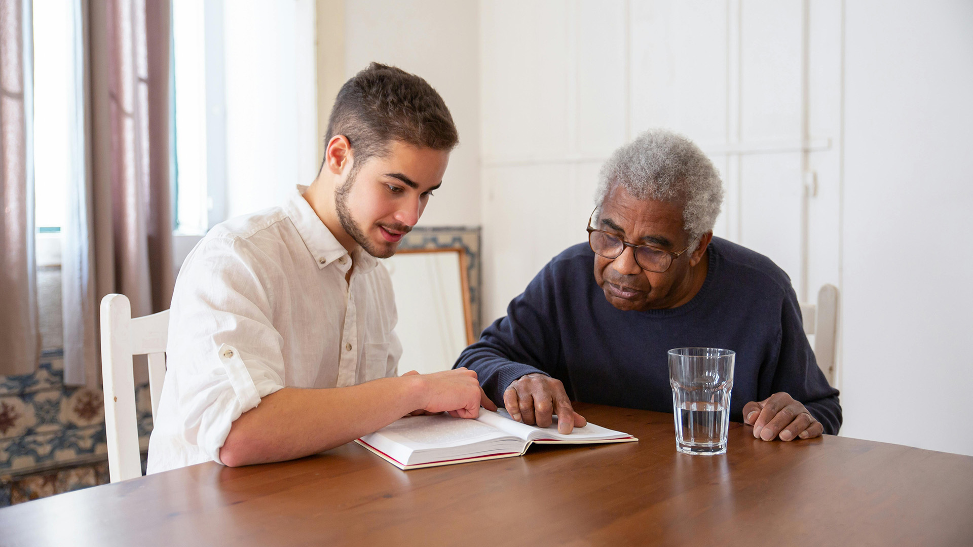 Caregiver reviewing a concept with an elderly patient